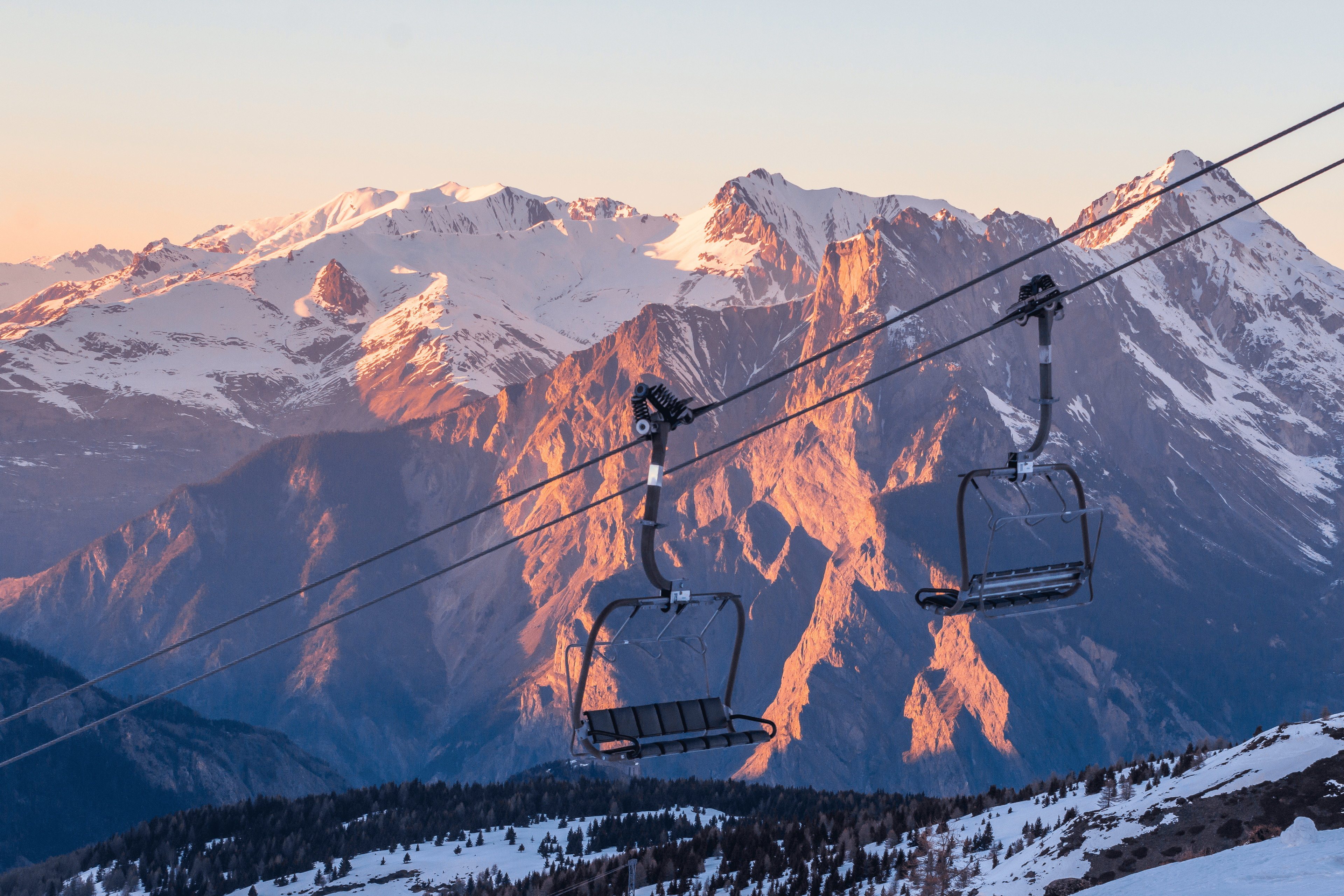 Empty chairlifts at sunset in ski resort