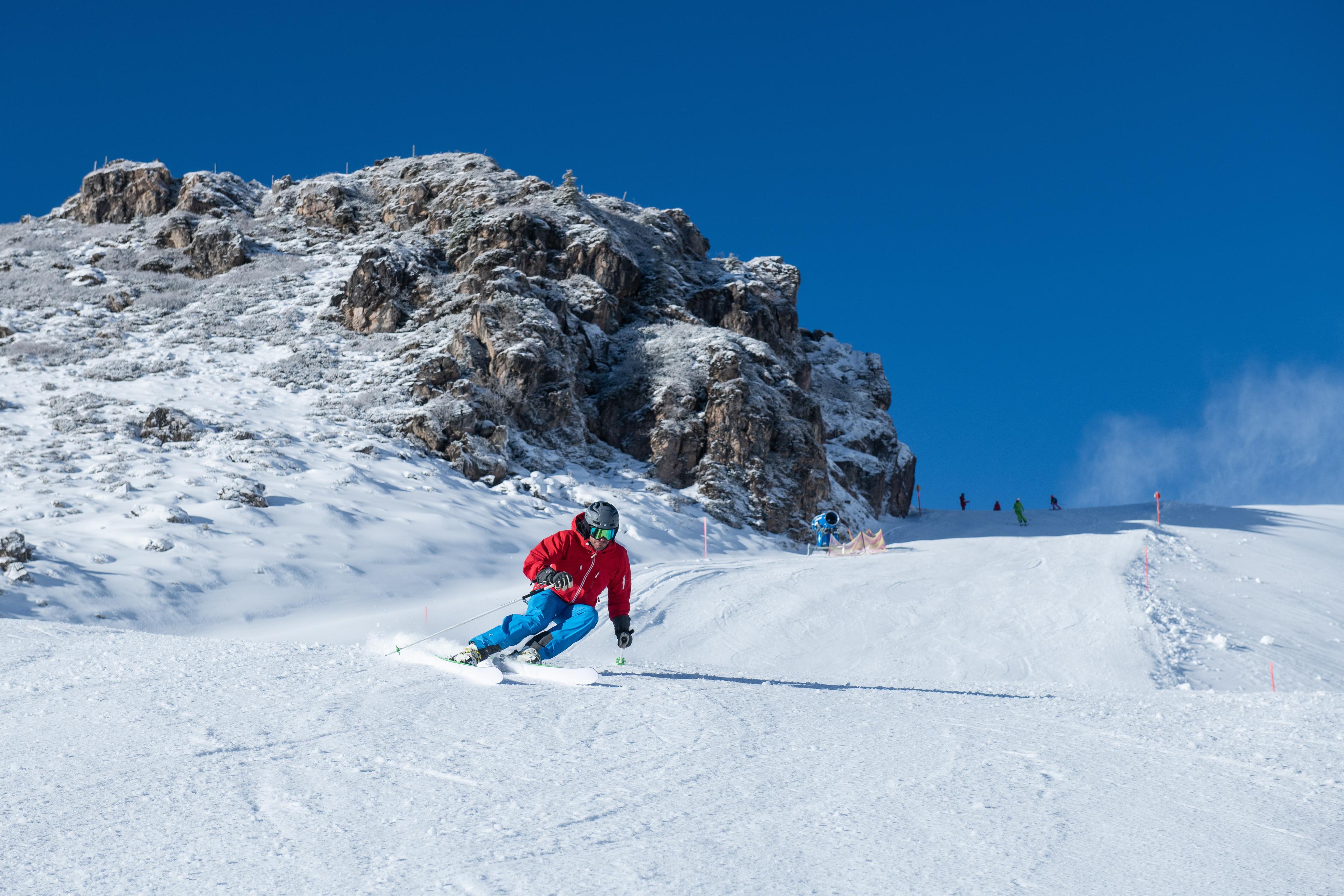 skier carving down kitzski ski area slope on an Austria ski holiday